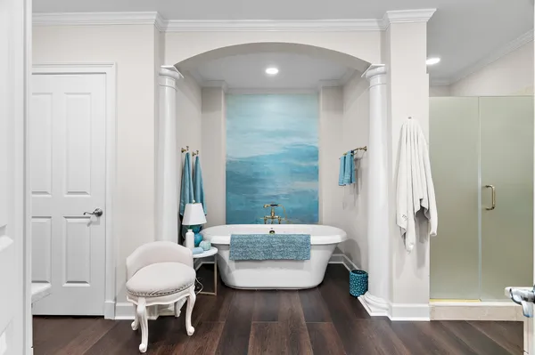 a bathroom with a toilet a sink a mirror and shower