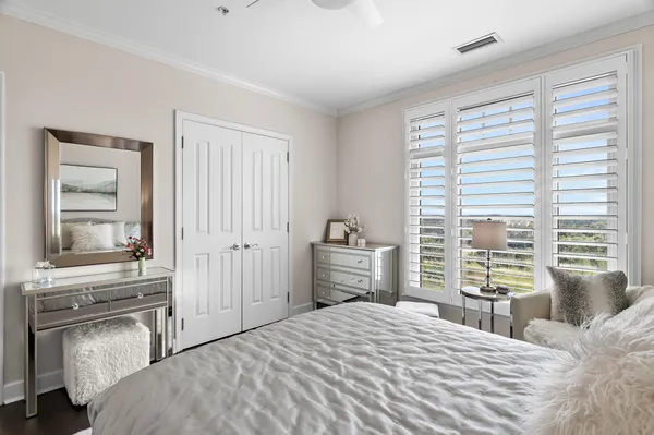 a bedroom with a bed and a large window