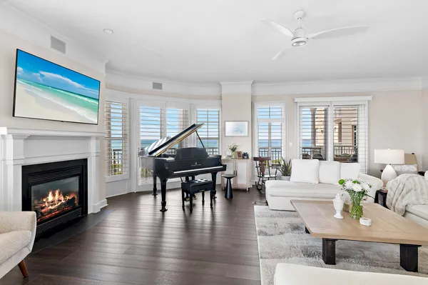 a living room with furniture a fireplace and wooden floor