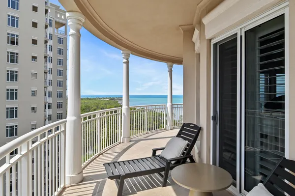a balcony with table and chairs