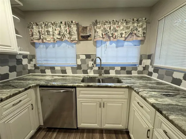 a kitchen with cabinets appliances and a counter top