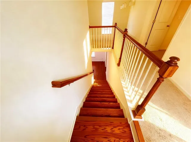 a view of a hallway with furniture and stairs