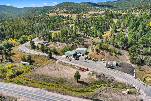 a view of a yard with wooden fence