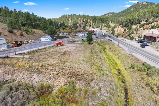 a view of a town with swimming pool and seating area