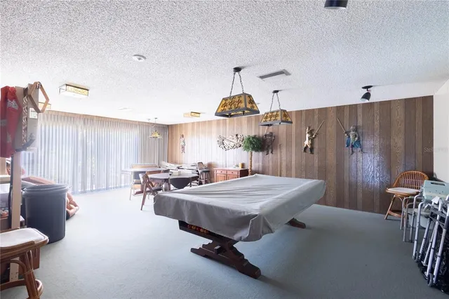 a living room with lots of furniture and a book shelf