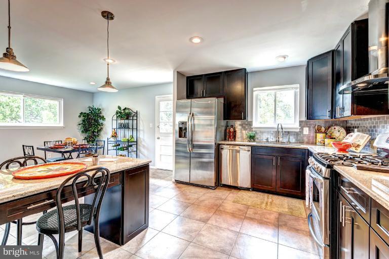 4537 Maryknoll Road Baltimore, MD 21208 - Photo 1 of 30 a kitchen with refrigerator a stove a sink and a chairs