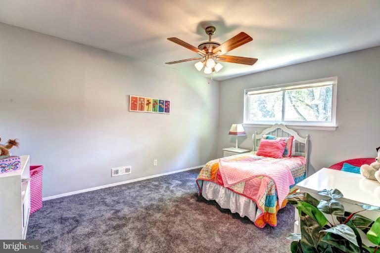 4537 Maryknoll Road Baltimore, MD 21208 - Photo 23 of 30 a bedroom with a bed and a chandelier