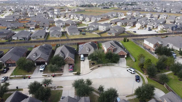 an aerial view of residential houses with outdoor space and swimming pool