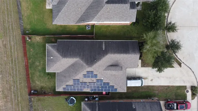an aerial view of residential houses with outdoor space and seating area
