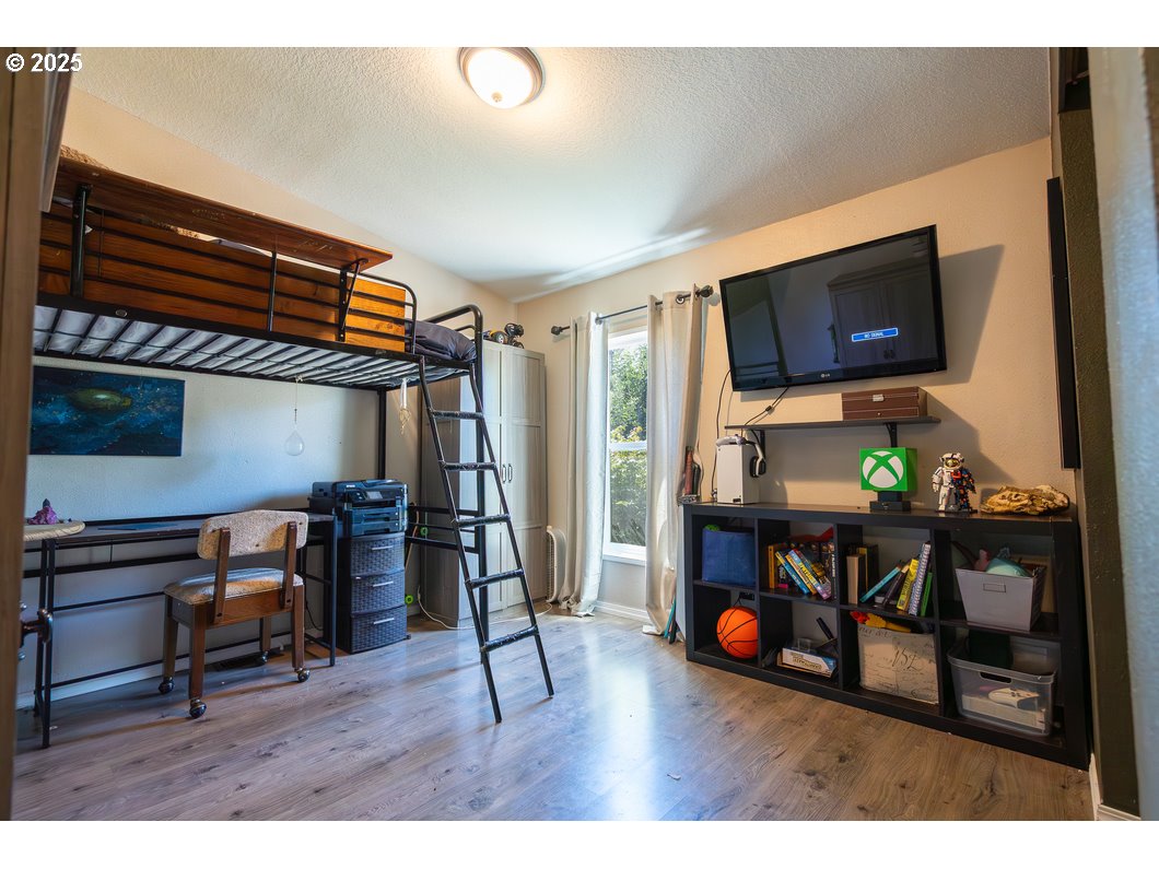 165 8th Place Mill City, OR 97360 - Photo 12 of 39 a living room with furniture a flat screen tv and a bookshelf