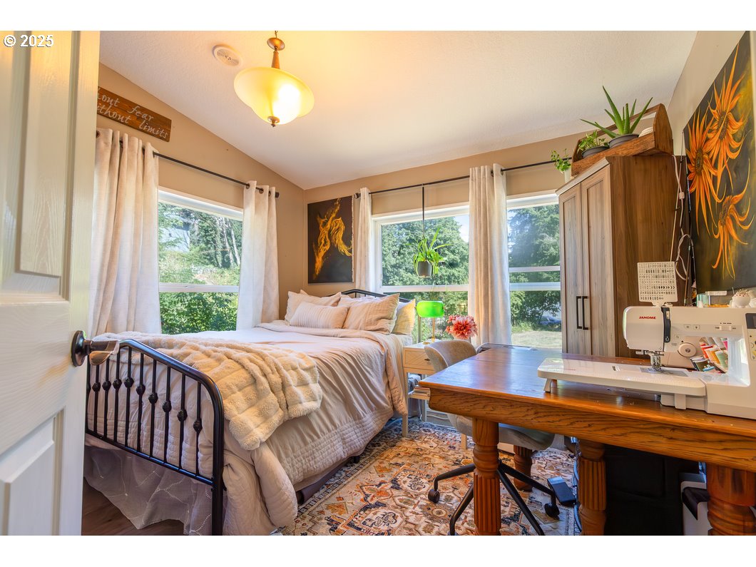 165 8th Place Mill City, OR 97360 - Photo 15 of 39 a bedroom with a bed and a large window