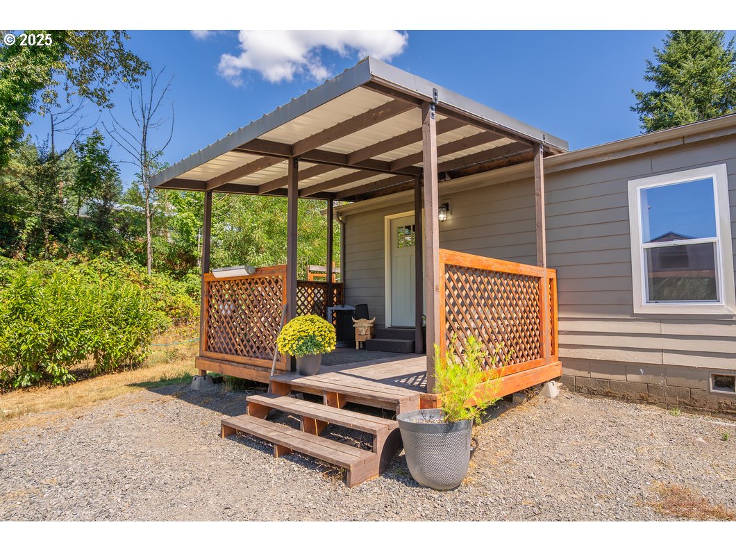 165 8th Place Mill City, OR 97360 - Photo 18 of 39 a backyard of a house with barbeque oven table and chairs