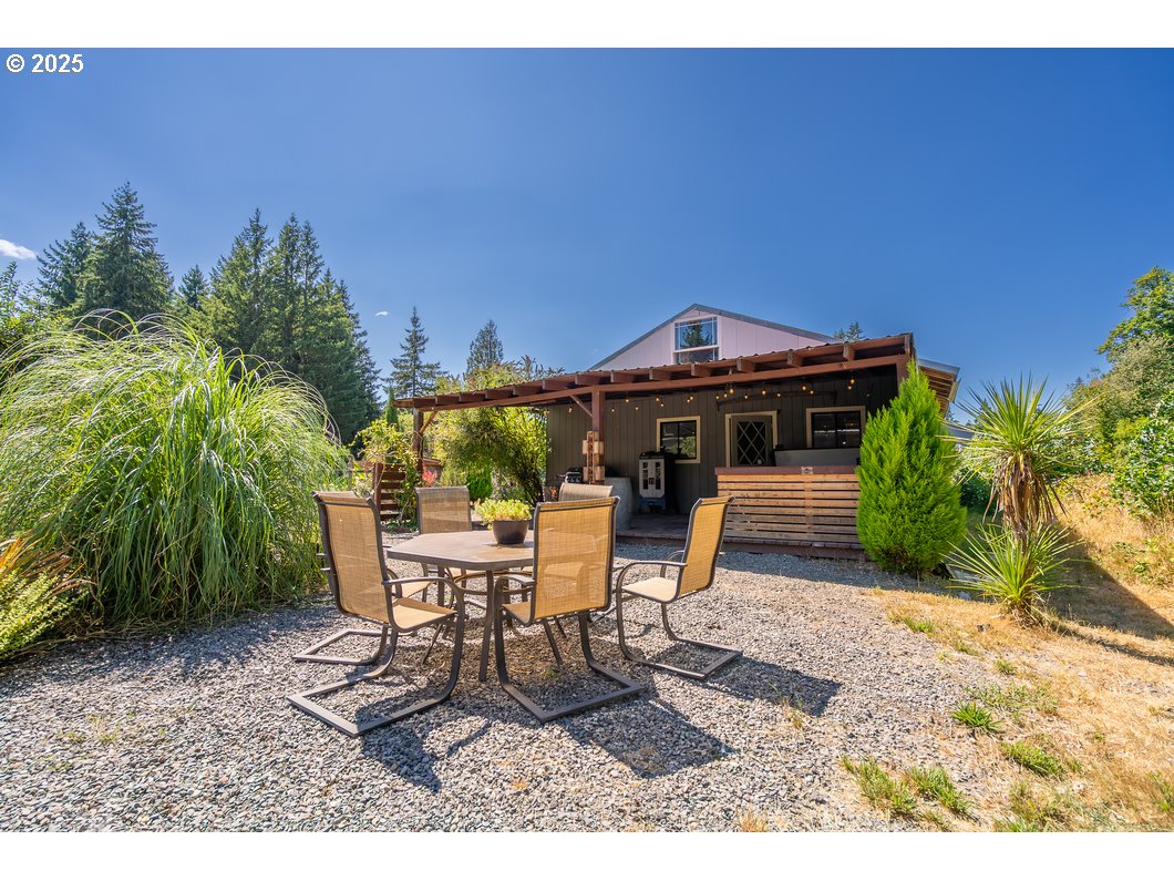 165 8th Place Mill City, OR 97360 - Photo 21 of 39 a view of a patio with table and chairs potted plants with wooden floor