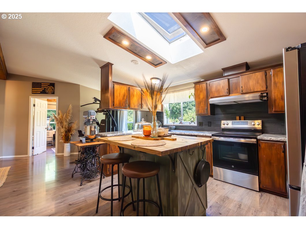 165 8th Place Mill City, OR 97360 - Photo 6 of 39 a kitchen with stainless steel appliances granite countertop a stove and a refrigerator