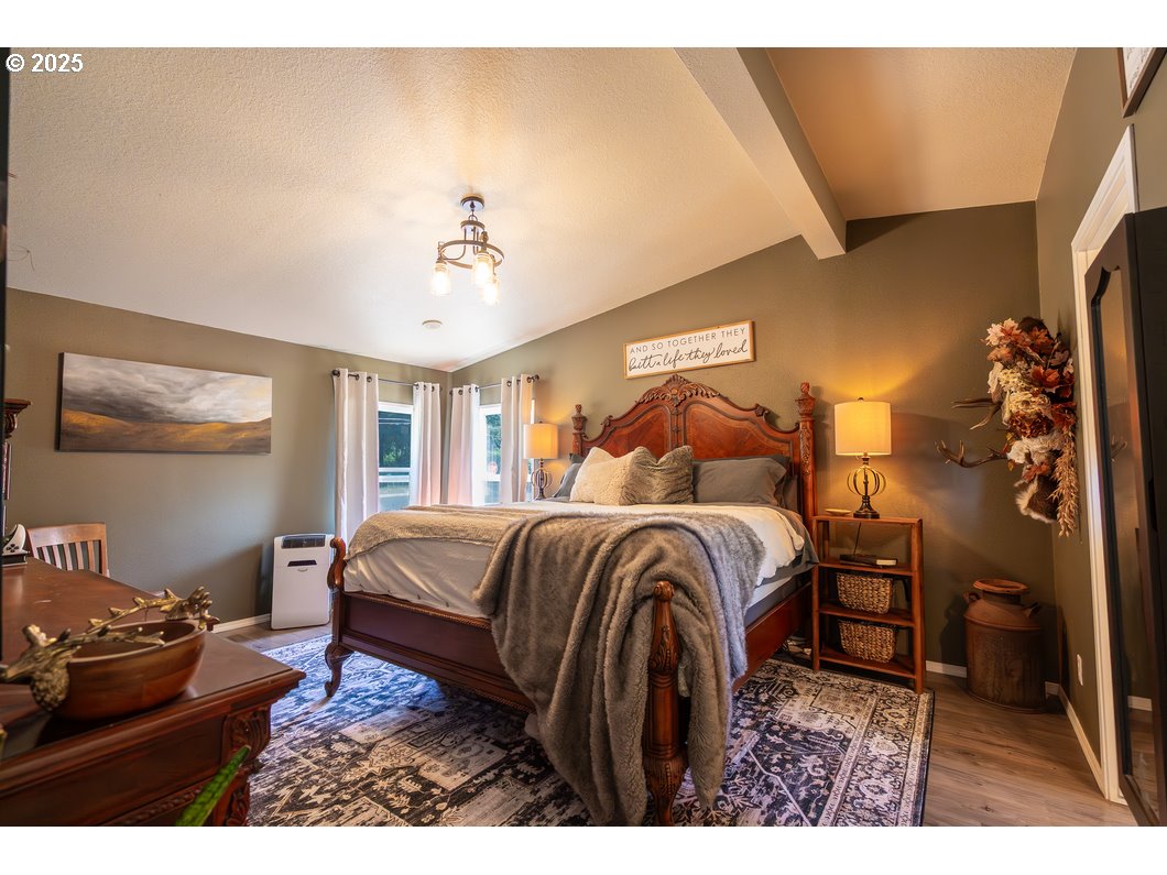 165 8th Place Mill City, OR 97360 - Photo 9 of 39 a bedroom with a bed and a chandelier