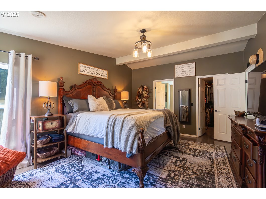 165 8th Place Mill City, OR 97360 - Photo 10 of 39 a bed room with a bed and a chandelier