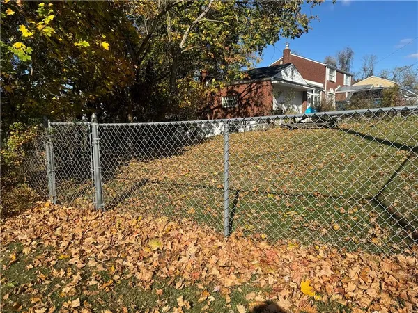 a view of house with wooden fence