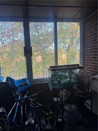 a living room with furniture and a floor to ceiling window