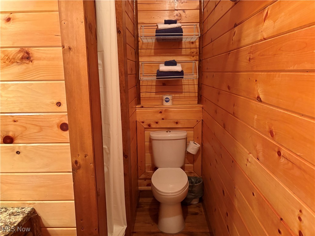 5919 Lake Road West, Unit 7 Ashtabula, OH 44004 - Photo 15 of 29 Bathroom featuring wood walls, vanity, and wood finished floors