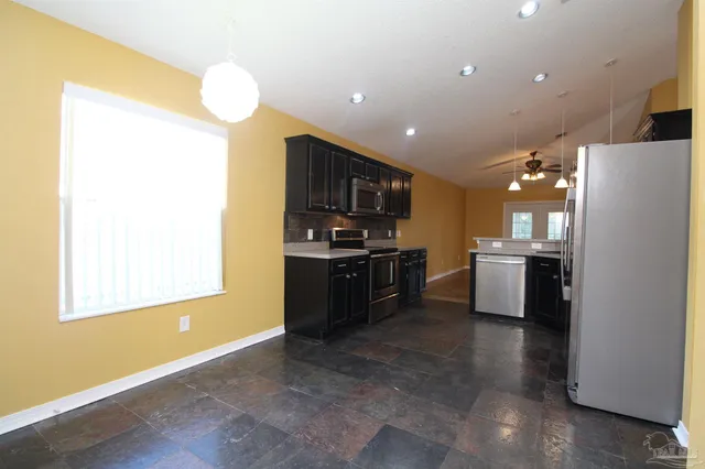 a kitchen with refrigerator and cabinets