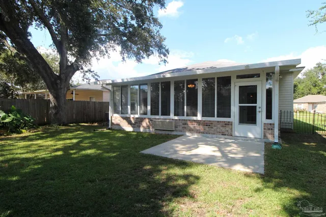 a view of a house with backyard and sitting area