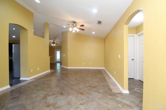 an empty room with a bathroom and a shower