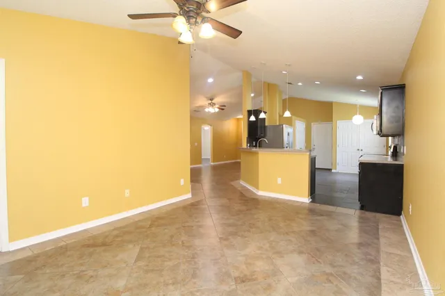 a view of a kitchen with a sink and a refrigerator