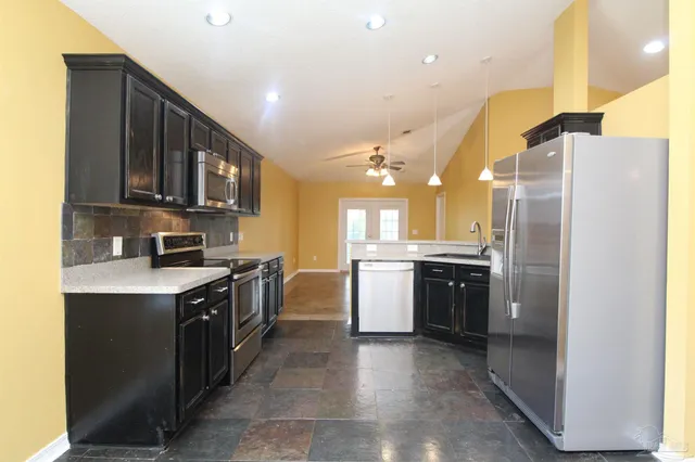 a kitchen with a sink cabinets and stainless steel appliances