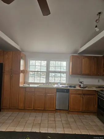 a kitchen with a sink a window and cabinets