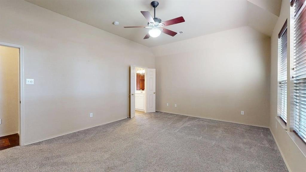 1910 Wickersham Lane Corinth, TX 76210 - Photo 16 of 38 an empty room with windows and fan