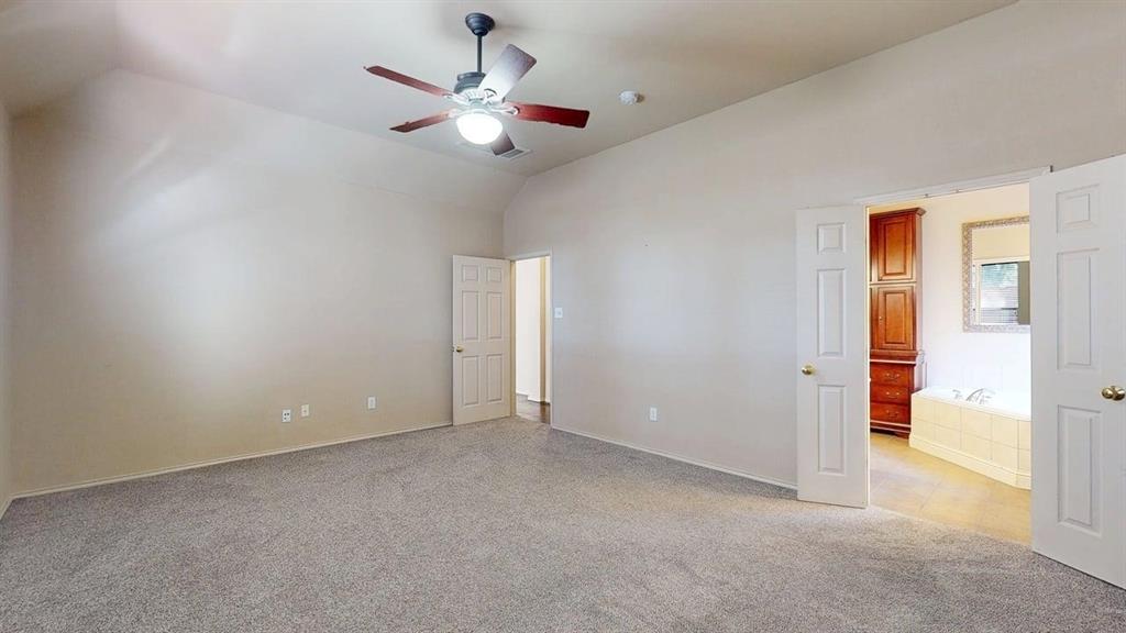 1910 Wickersham Lane Corinth, TX 76210 - Photo 17 of 38 an empty room with closet and a chandelier fan