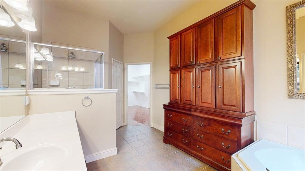 1910 Wickersham Lane Corinth, TX 76210 - Photo 18 of 38 a bathroom with a sink a toilet and tub