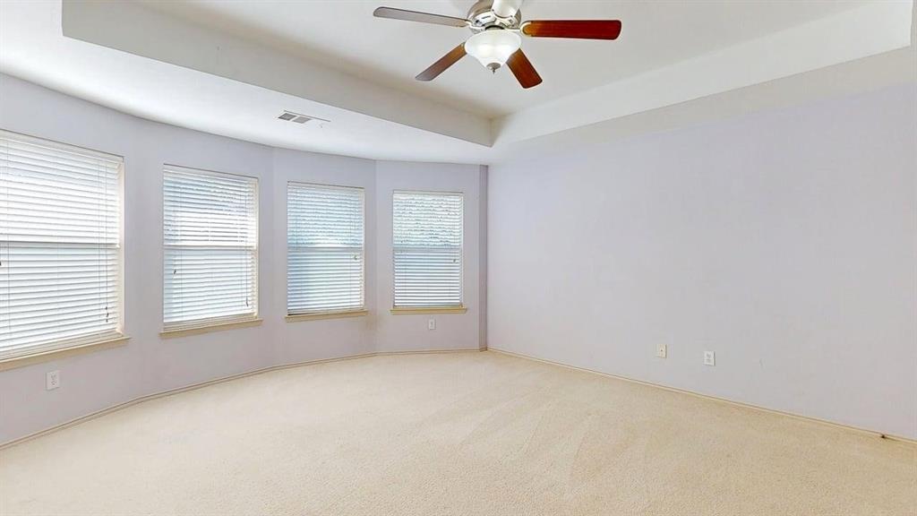 1910 Wickersham Lane Corinth, TX 76210 - Photo 32 of 38 an empty room with windows and fan