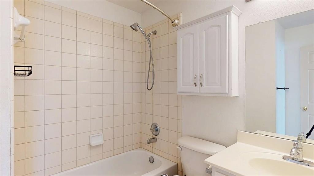 1910 Wickersham Lane Corinth, TX 76210 - Photo 36 of 38 a bathroom with a sink a toilet and shower