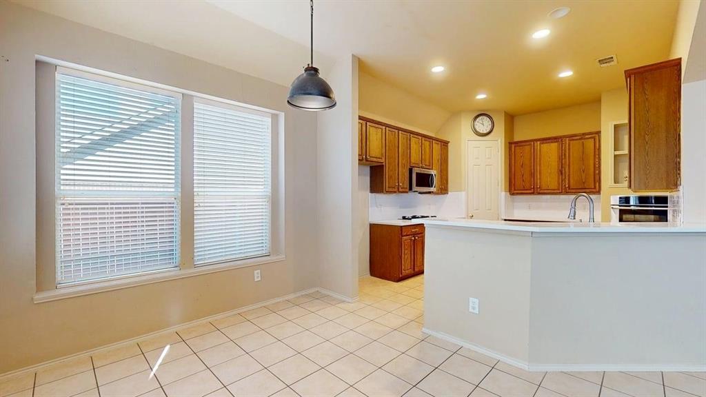 1910 Wickersham Lane Corinth, TX 76210 - Photo 6 of 38 a view of kitchen with stainless steel appliances granite countertop a stove a sink a refrigerator and cabinets