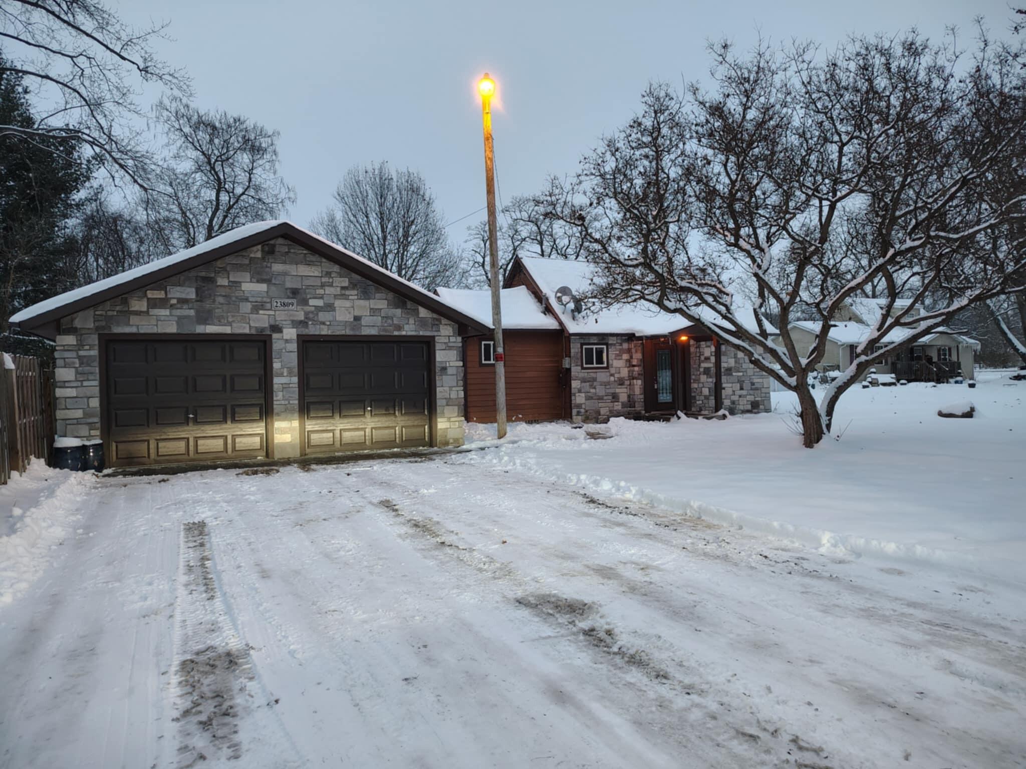 23809 Shelby Road Lowell, IN 46356 - Photo 1 of 19 a front view of a house with a yard and garage