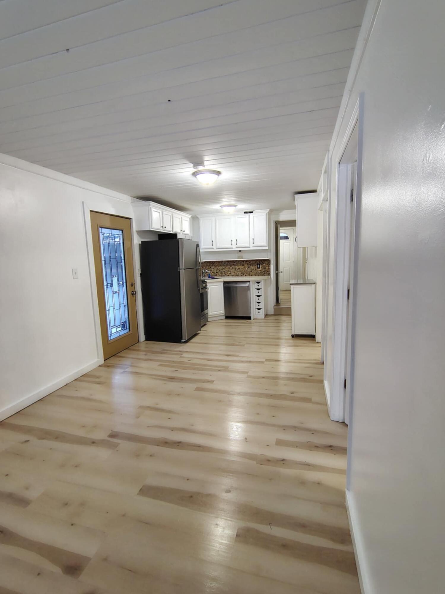 23809 Shelby Road Lowell, IN 46356 - Photo 2 of 19 a view of a electric appliances in kitchen and empty room with wooden floor