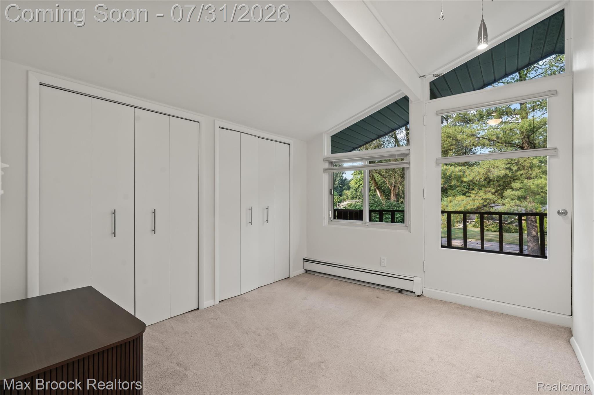 29630 Sugar Spring Road Farmington, MI 48334 - Photo 23 of 41 Bedroom #2 with vaulted ceiling, expansive windows, door to balcony, neutral carpeting, and large closet