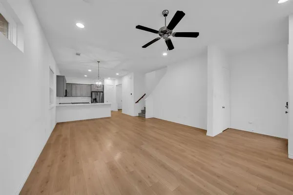 a view of an empty room with a ceiling fan