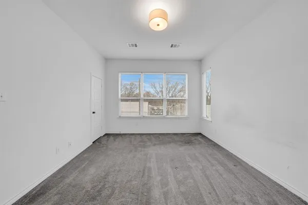 a view of an empty room and a window