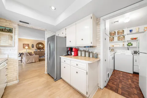 a kitchen with a sink cabinets and wooden floor
