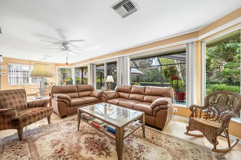 a living room with furniture potted plant and a large window