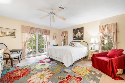 a bed room with a bed a table and a large mirror