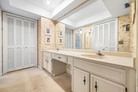 a spacious bathroom with a double vanity sink mirror and