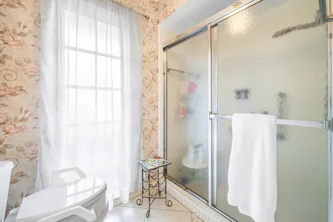 a bathroom with a granite countertop shower and a sink