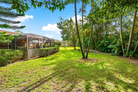 a aerial view of a house with a big yard and potted plants