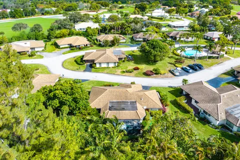 an aerial view of a house with swimming pool and outdoor space