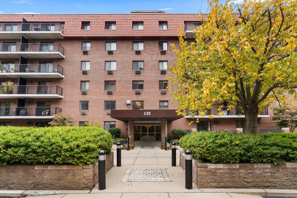 a front view of a building with garden
