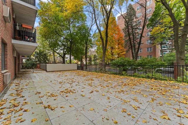a backyard of a house with large trees