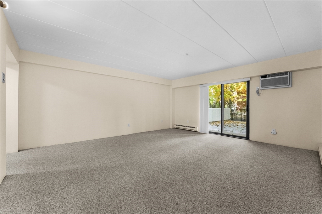 135 Pleasant Street, Unit 106 Brookline, MA 02446 - Photo 13 of 27 an empty room with windows